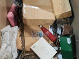a cardboard box full of assorted items in it