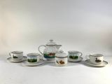 a tea set with cups and saucers on a table