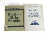 two books sitting on top of each other on a white surface
