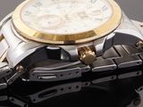 a close up of a watch on a black surface