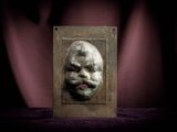a metal plaque with a picture of a man ' s face on it