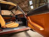 a car that is sitting in a garage with its door open