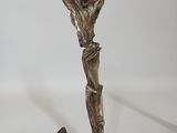 a bronze statue of a man holding a cross on a white background