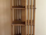 une grande armoire en bois avec une porte vitrée, montée sur roulettes
