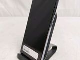 a cell phone that is on a stand on a table