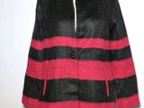 a black and red coat on a mannequin stand