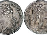 a close up of a coin with a woman on it