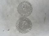 two clear glass plates sitting on a white surface