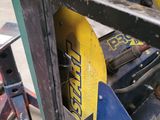 a picture of a forklift with a yellow sign on it