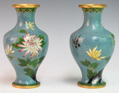 pair of blue vases with flowers and birds painted on them