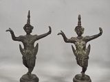 three bronze figurines of a woman and a man on a pedestal