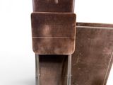 two brown chairs sitting next to each other on a white surface