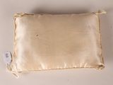 a close up of a pillow with a tag on it