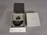 a black object in a white box on a table