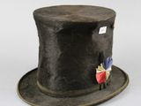 a black top hat with a red and blue flag on it