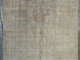 a beige rug with stripes on a grey background