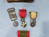 an assortment of medals including a medal, a medal, and a book