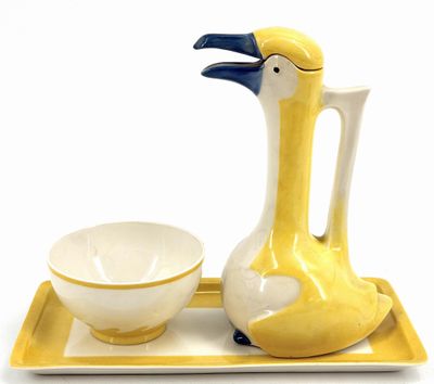 a yellow tray with a white bowl and a yellow bird on it
