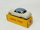a toy car on top of a box on a white surface