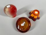 three glass vases sitting next to each other on a table