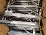 a lot of metal parts in a box on the floor