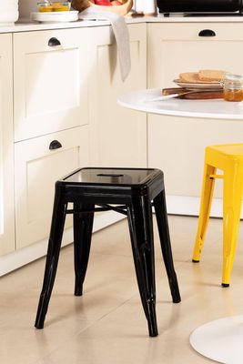 a small table with two stools in the kitchen