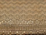 a close up view of a woven tablecloth on a table