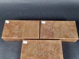 three wooden boxes with labels on them sitting on a table