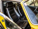 a close up of a yellow car with black leather seats