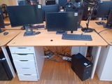 a computer desk with two monitors and a keyboard on it