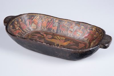 an old wooden bowl with a decorative design on it