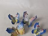 four small butterflies that are sitting on a table
