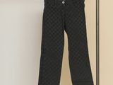 black pants hanging on a clothes rack in a room