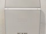 a white box with a button on the side of it