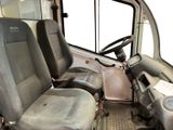 two seats in the front of a truck with a steering wheel