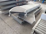 a conveyor belt in the middle of a warehouse