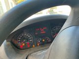 steering wheel of a car with a speedometer, gauges, and other instruments