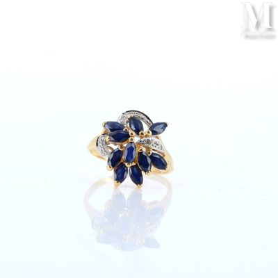 an image of a diamond and sapphire ring on a white surface