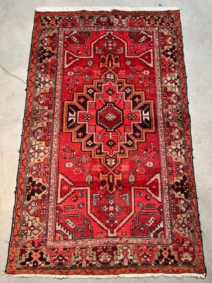 rug on the floor is red and black with a pattern on it