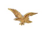 an image of a gold eagle brooch on a white background