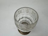 a glass cup that is sitting on a table