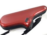 a red guitar case sitting on a white surface
