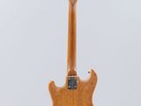 an electric guitar hanging from a string on a white background