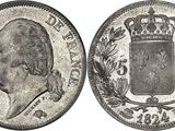 a silver coin with a crown on top of it
