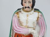 a figurine of a man with a sword and shield