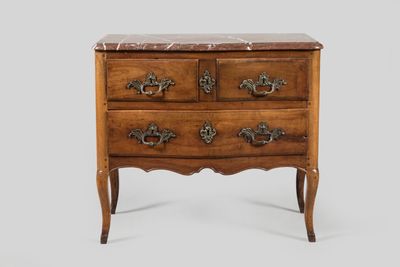 an antique chest of drawers with marble top