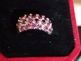 a close up of a pink diamond ring in a black box