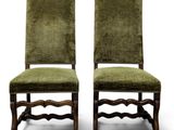 a pair of green upholstered chairs on a white background