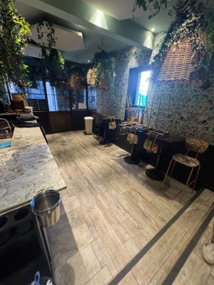 an image of a room with a lot of plants on the walls