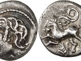 a silver coin with an image of a horse on it